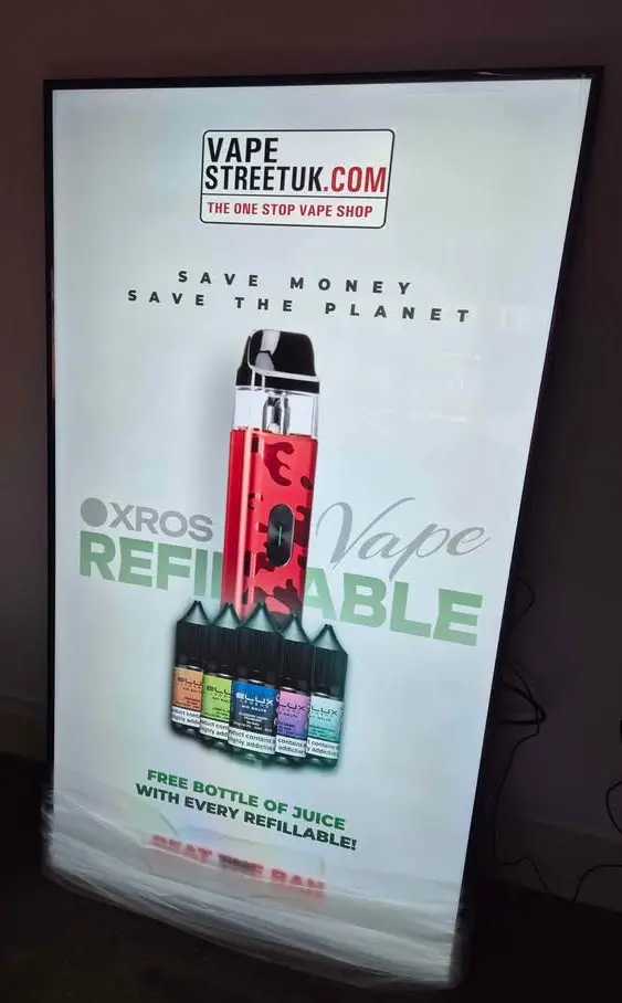 Commercial digital display in a UK business promoting services.