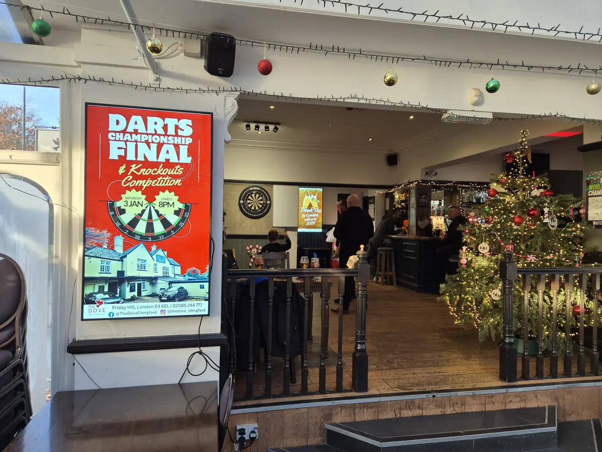 Digital display behind the bar showing weekly events and offers.