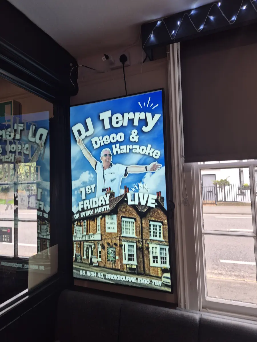 Pub screen displaying live sport schedule and bar promotions.