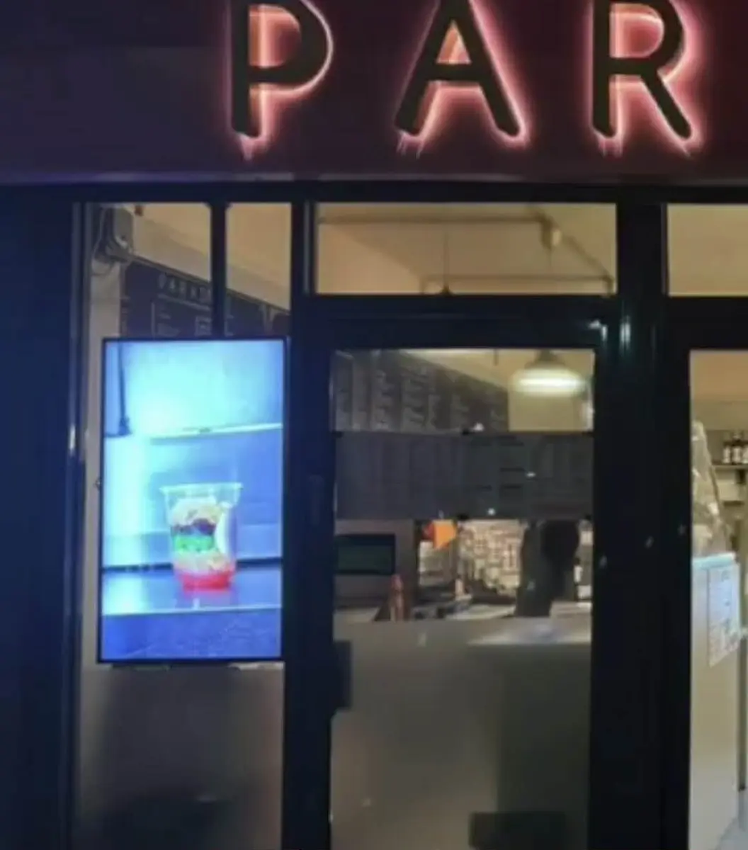 Digital signage displaying combos and new menu items in a fast food outlet.